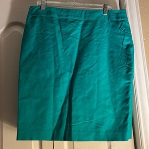 A paris green skirt with a back zipper and slit.